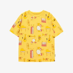 T-shirt ample jaune avec motif d'instruments de musique en jersey doux, enfant || Loose-fitting yellow t-shirt with musical instruments all over print in soft jersey, child